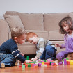Toddlers playing with bricks