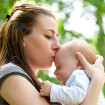 Mother kissing baby