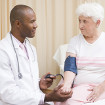 A doctor taking a patient's blood pressure