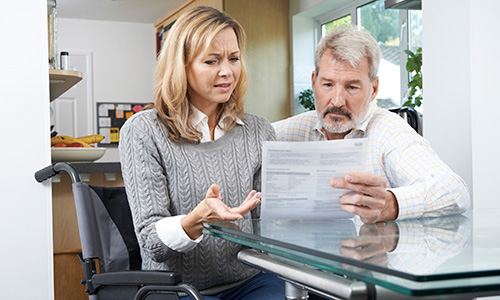 Woman in wheelchair reading a letter