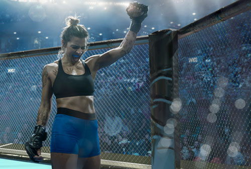 MMA fighter raising her glove in victory