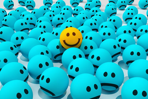 A happy face in a crowd of sad faces