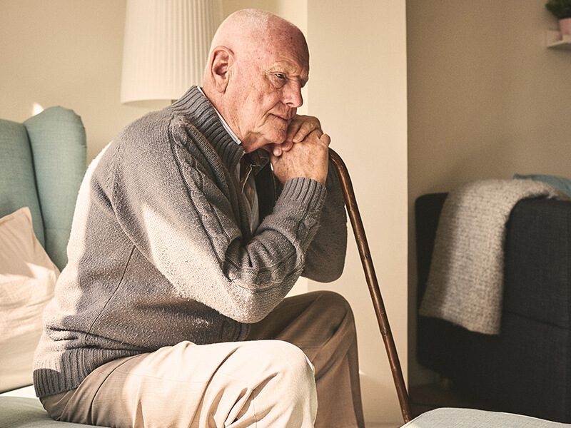 Elderly man sitting alone