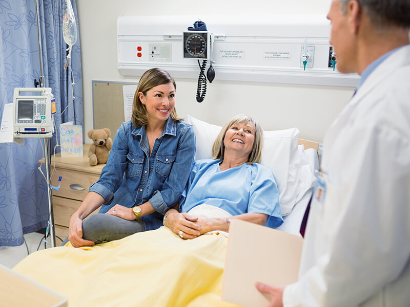 Doctor speaking with patient and relative