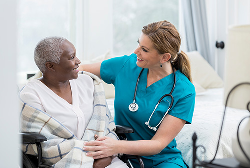 Nurse caring for a patient in a wheelchair