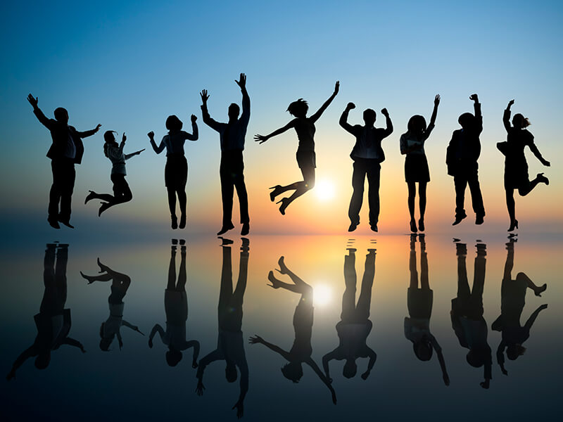 Silhouette of people jumping for joy