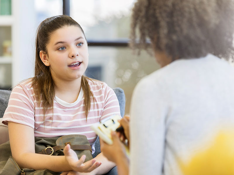 A child speaking with a social worker