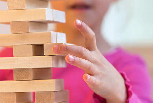 A girl playing Jenga
