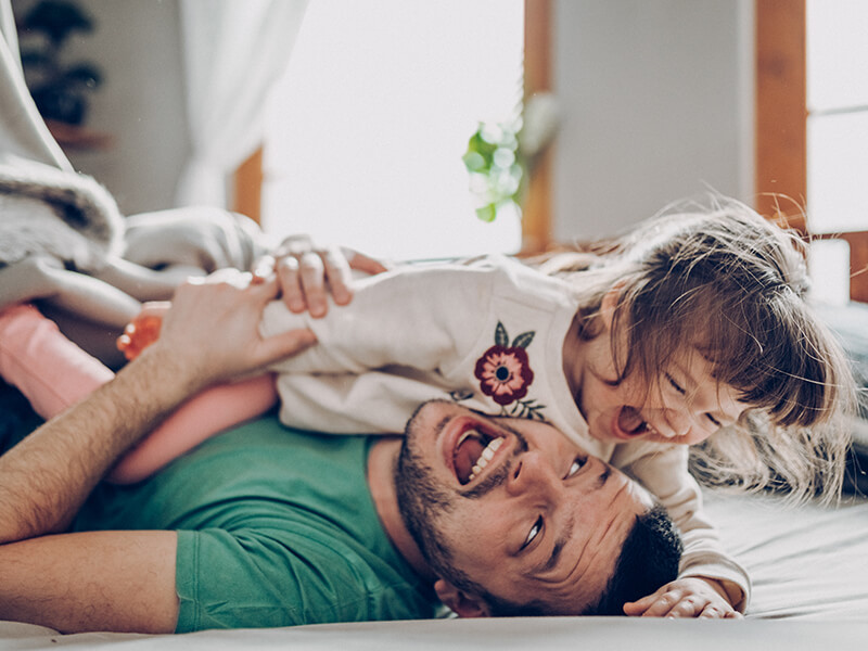 man playing with daughter