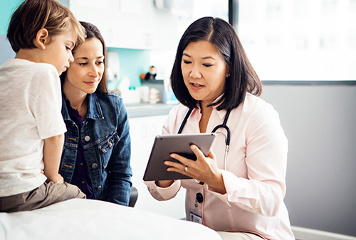 Doctor talking to mother and child