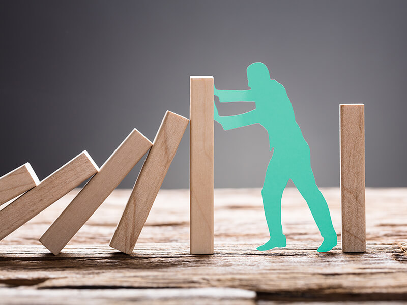 Outline of man resisting falling blocks