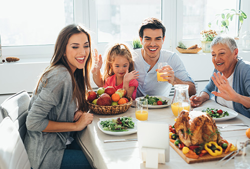 A family having a video call during dinner