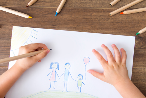 Child drawing a happy family