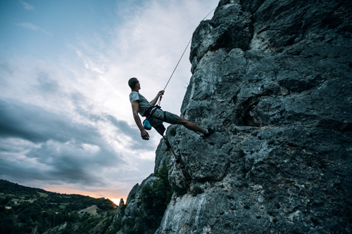 Disabled man rock climbing
