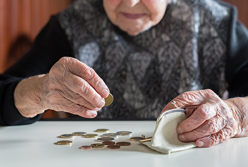 Elderly woman counting money