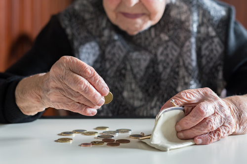 Elderly woman counting money