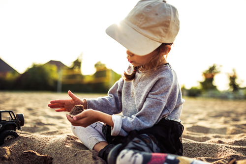 Little girl playing in sand