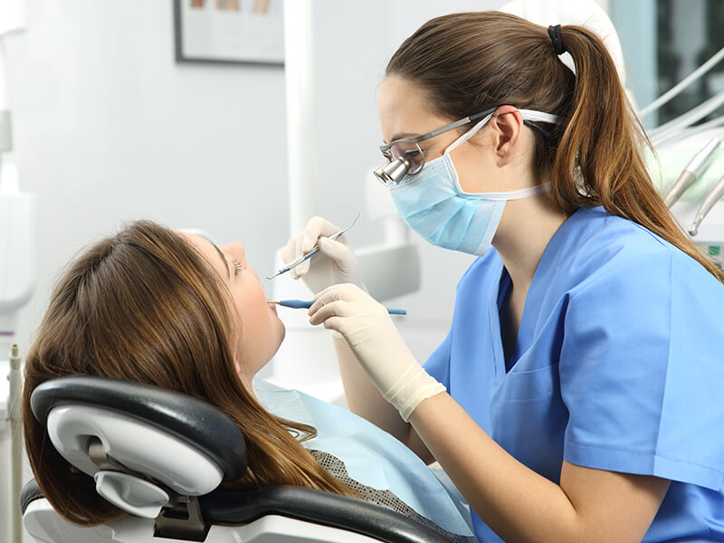 Dentist examining teeth