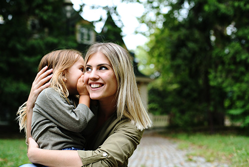 Daughter whispers in mother's ear