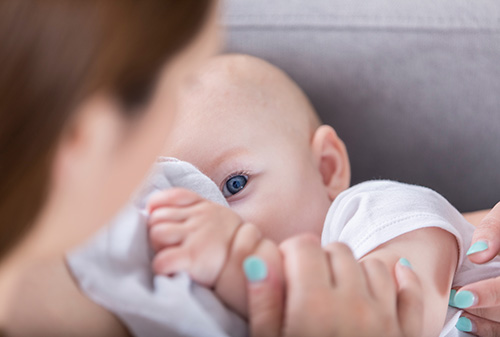 Baby looking up at mother