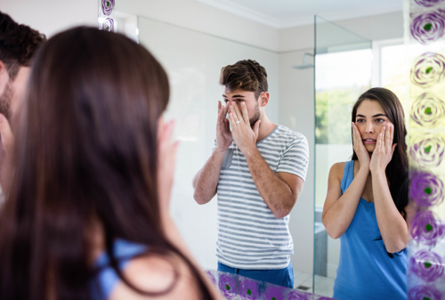 Couple looking in the mirror