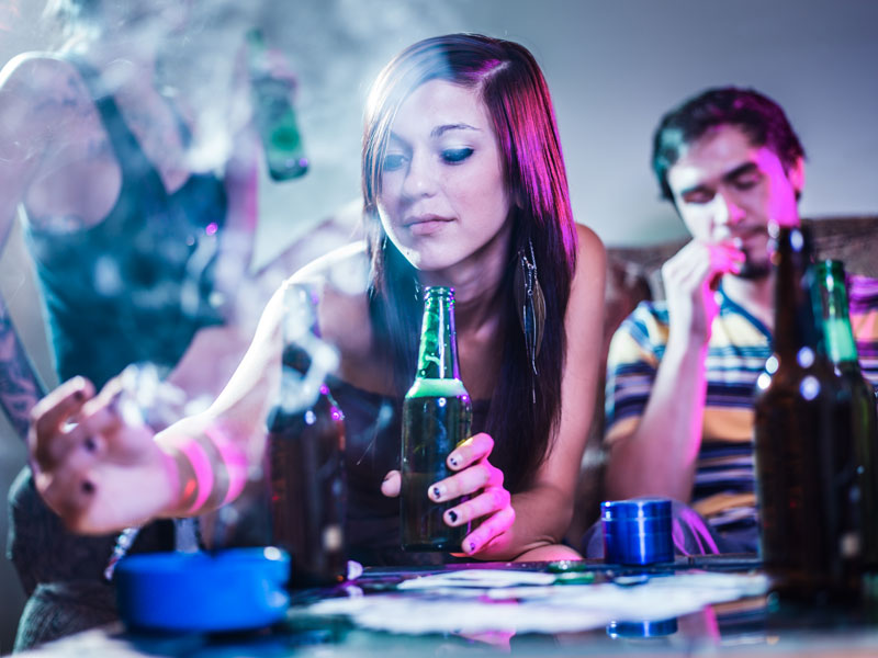 Young womand drinking and smoking