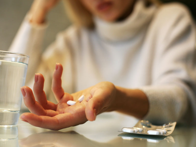 Woman holding pills