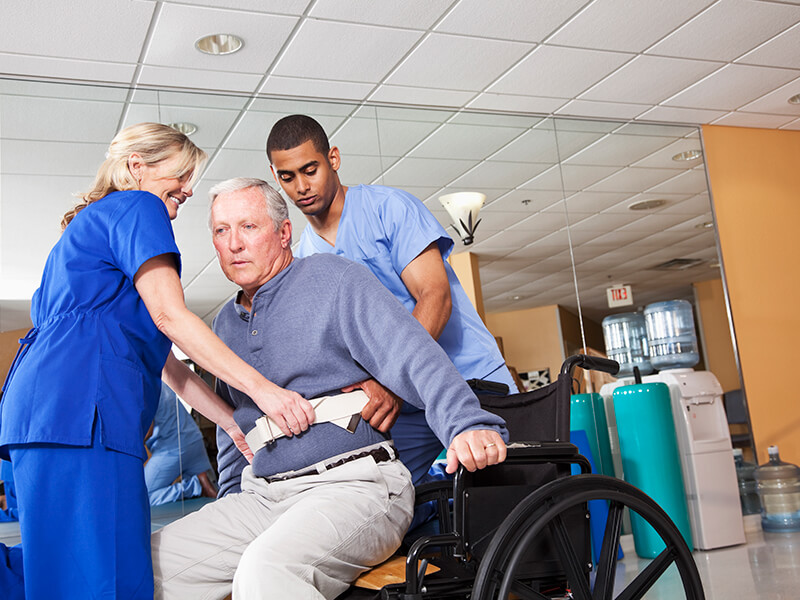 Helping patient into wheelchair
