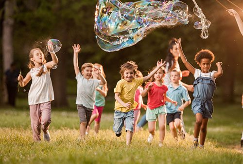 Children running through a field