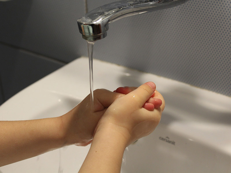 A child washing their hands