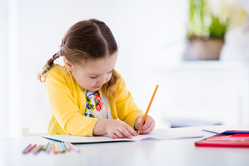 Girl painting and writing