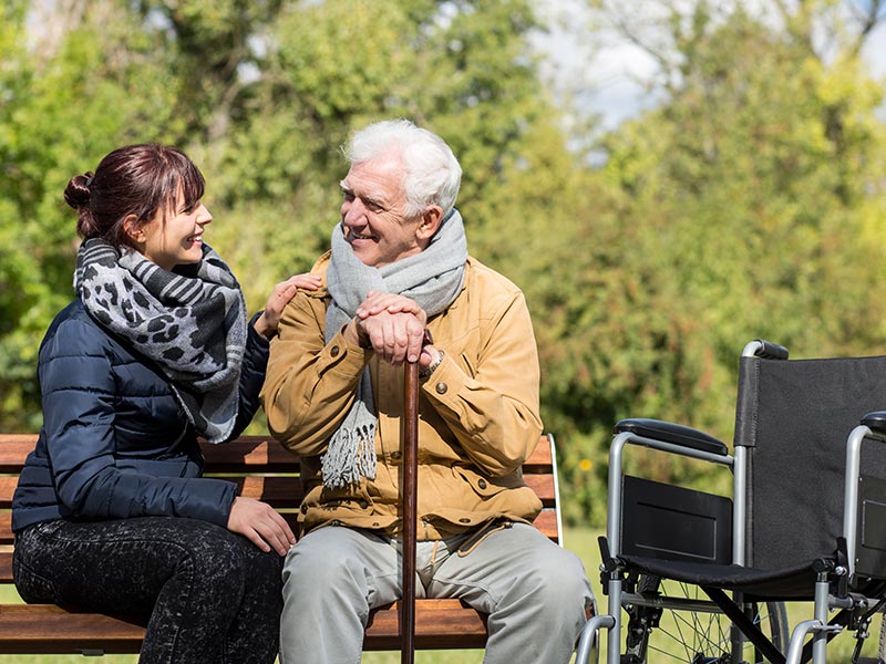 An elderly man and a carer