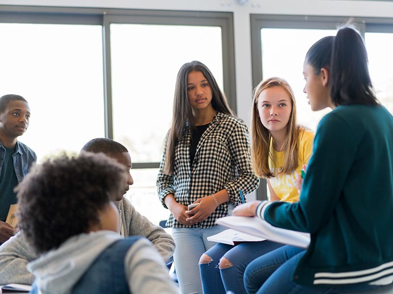A group of multi-ethnic teenagers in discussion