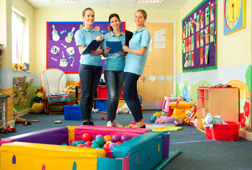 Teachers standing in nursery classroom