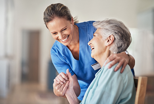Carer and older lady smiling