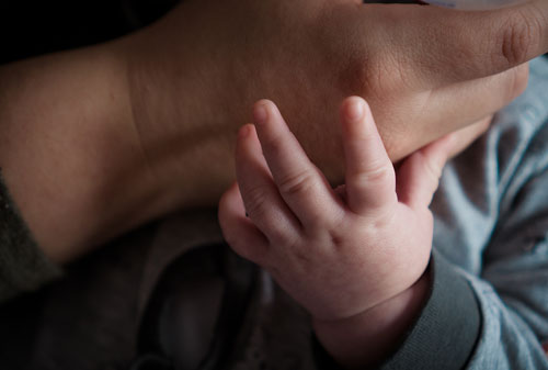 baby holding its mum