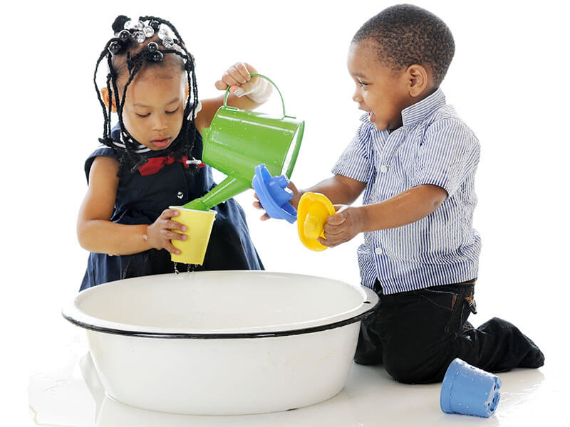 Toddlers playing with water together