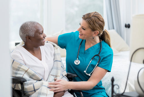 Nurse caring for patient in wheelchair