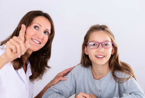 Optometrist checking eye vision of a girl
