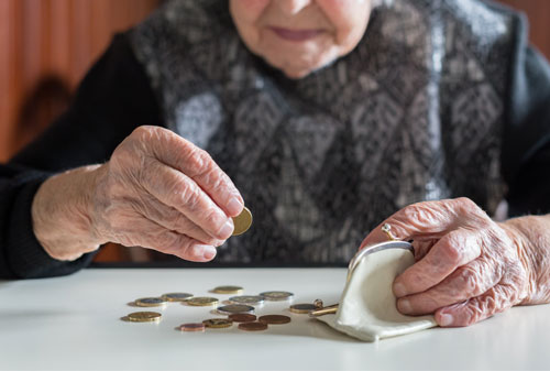 Elderly woman counting money