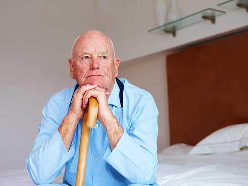 Resting hands and chin on walking stick