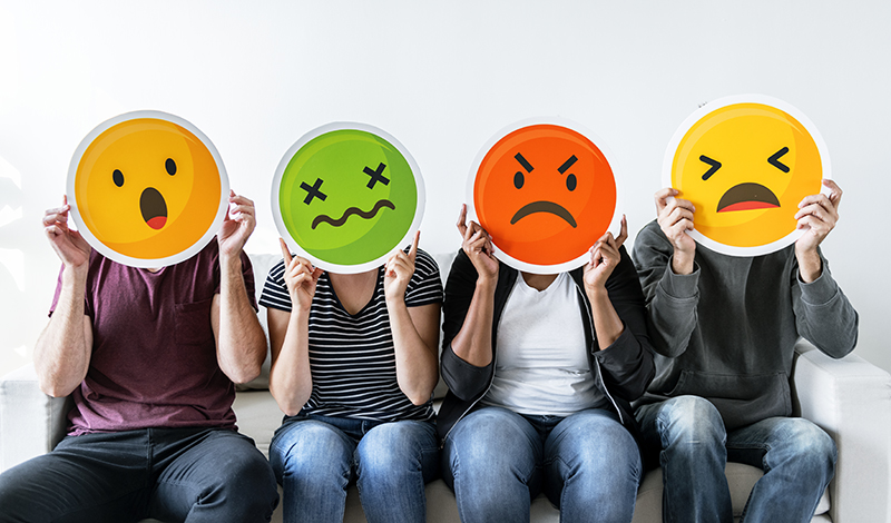 People holding emoticons