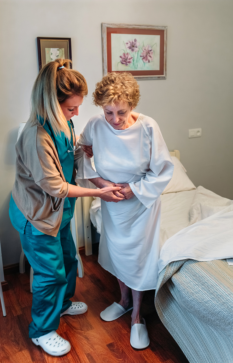 Care giver helping elderly woman