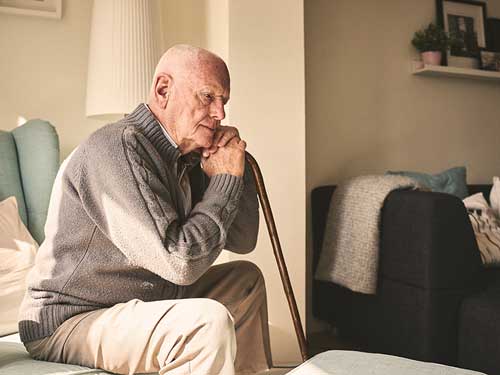 Elderly man sitting alone