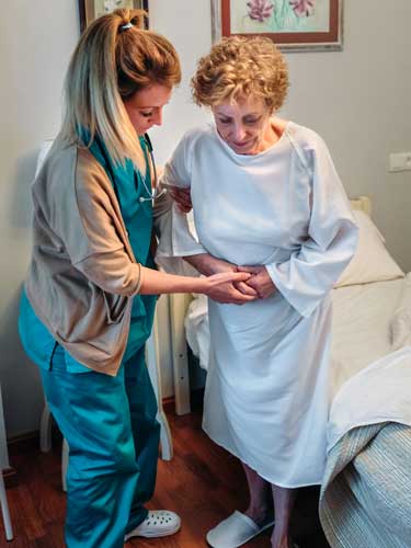 Caregiver helping elderly woman