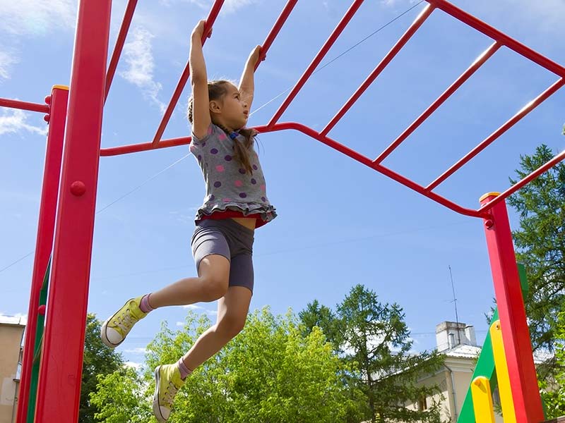A girl swinging on bars