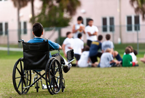 A boy in a wheelchair being left out of activities