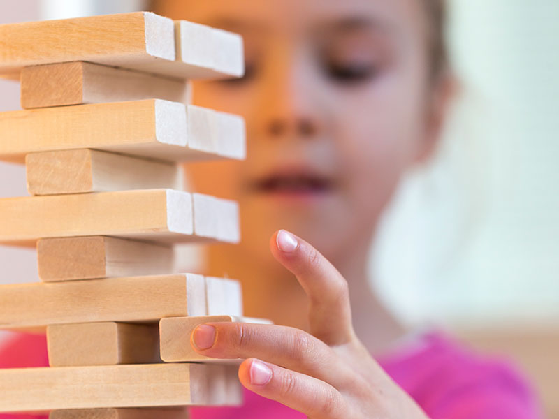 A girl playing Jenga
