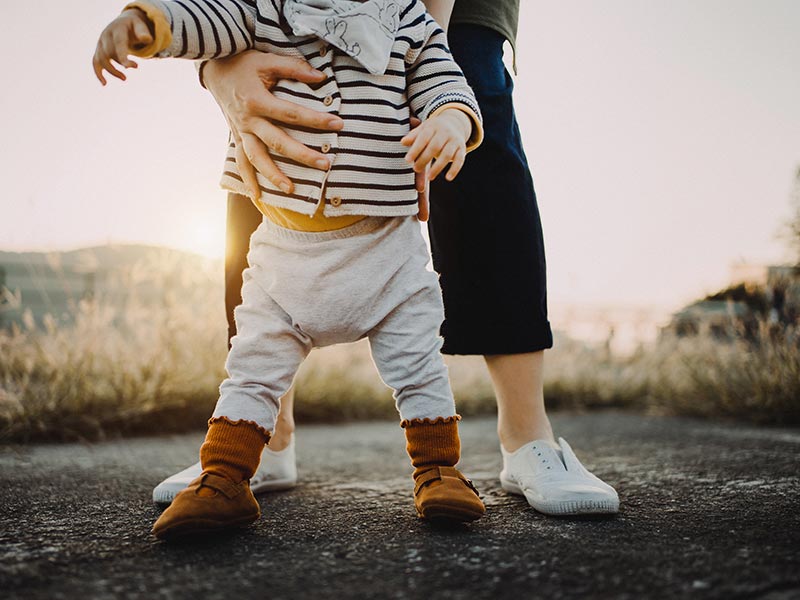 A young child learning to walk