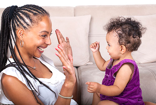 A mother and her young daughter playing